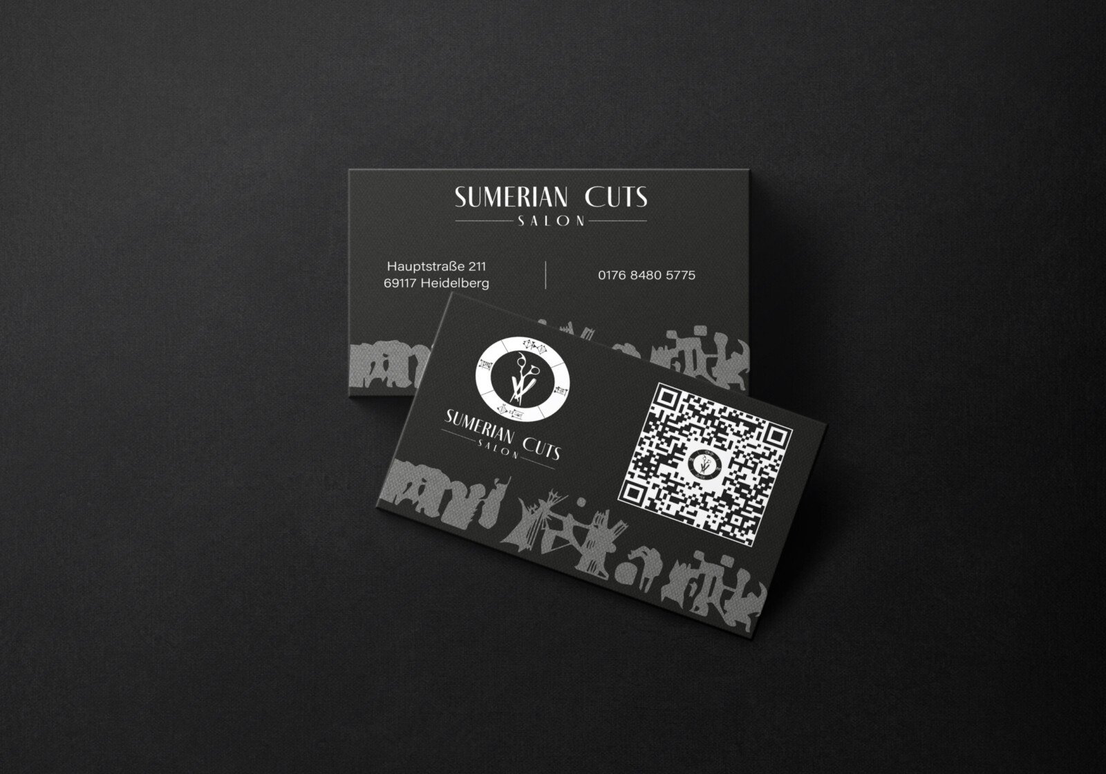 Sumerian Cuts black business cards with the salon logo and heritage motifs